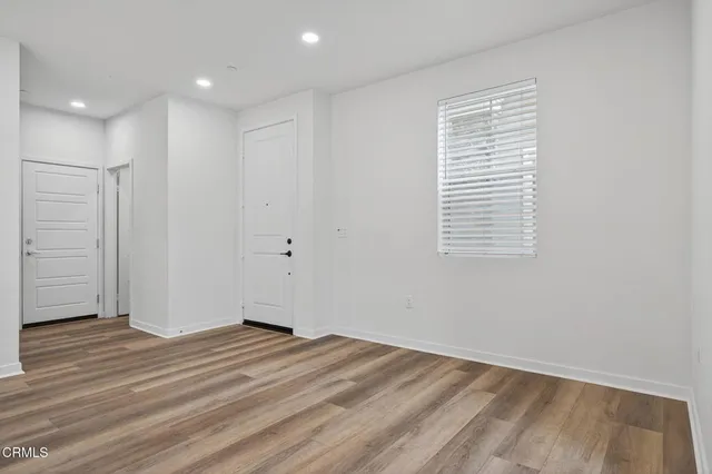 a view of kitchen with kitchen island stainless steel appliances refrigerator stove microwave and cabinets