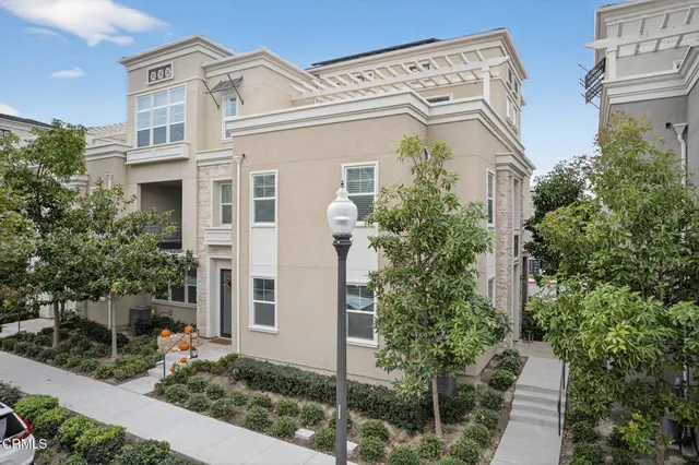 a living room with furniture a flat screen tv and kitchen view