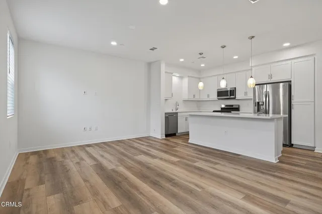 a kitchen with stainless steel appliances a stove sink microwave and cabinets