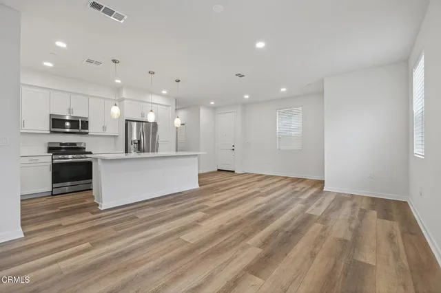 a kitchen with cabinets stainless steel appliances and a sink