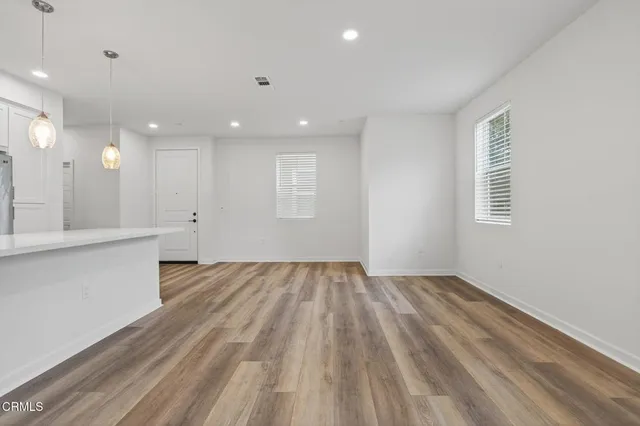 a kitchen with kitchen island a sink stainless steel appliances and cabinets