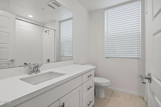 a bathroom with a glass shower door