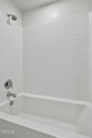 an empty room with closet and a chandelier fan