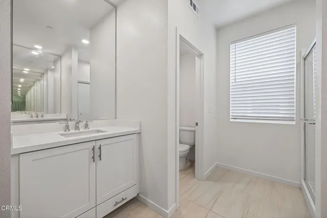 a view of a patio with a table and chairs under an umbrella