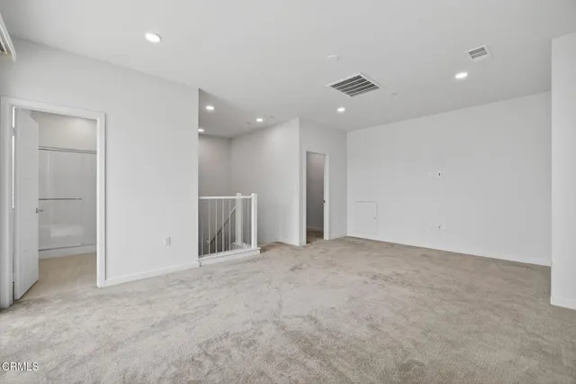 a view of a chairs and table in patio with a swimming pool