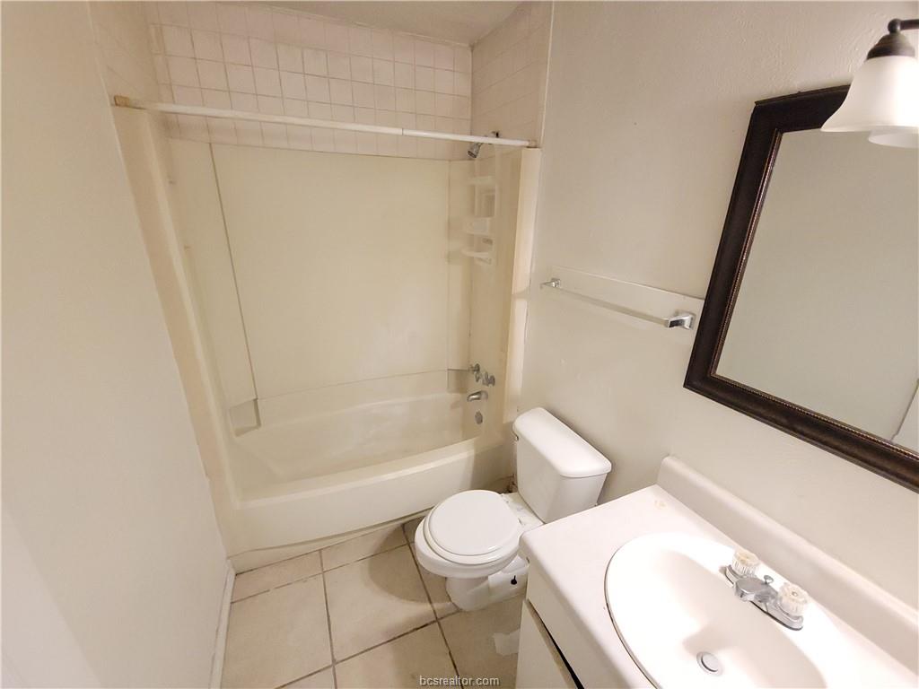 2712 Evergreen Circle Bryan, TX 77801 - Photo 24 of 30 Full bathroom with tile patterned flooring, vanity, toilet, and shower / bath combination