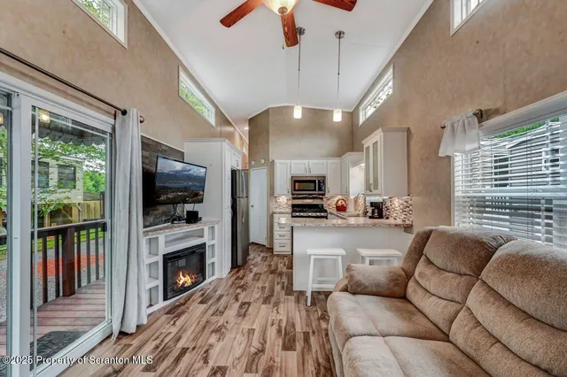 a kitchen with granite countertop a refrigerator a sink a stove and cabinets
