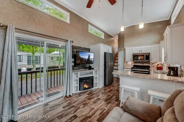 a kitchen with a refrigerator and a stove top oven