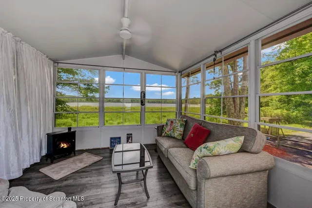 a view of a house with backyard and a tree