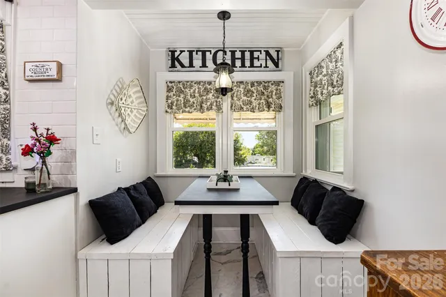 a kitchen with kitchen island granite countertop a sink cabinets and window