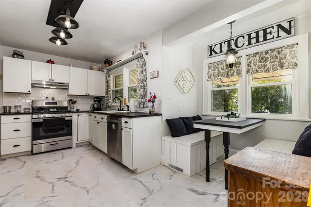 a room with pool table and windows