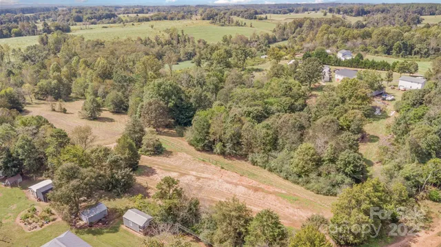 a view of a yard with wooden fence