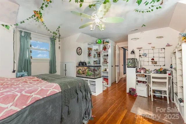 a bedroom with a bed and a view of kitchen