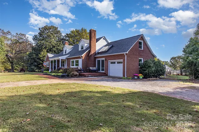 a front view of a house with swimming pool having outdoor seating
