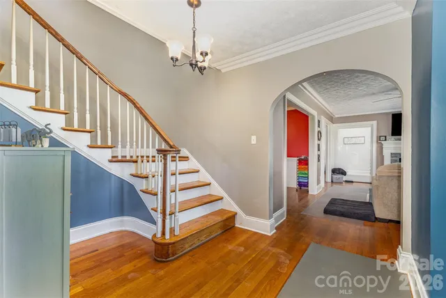 a view of entryway and hall with wooden floor