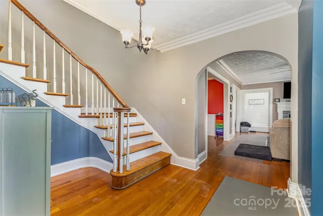 a view of entryway and hall with wooden floor