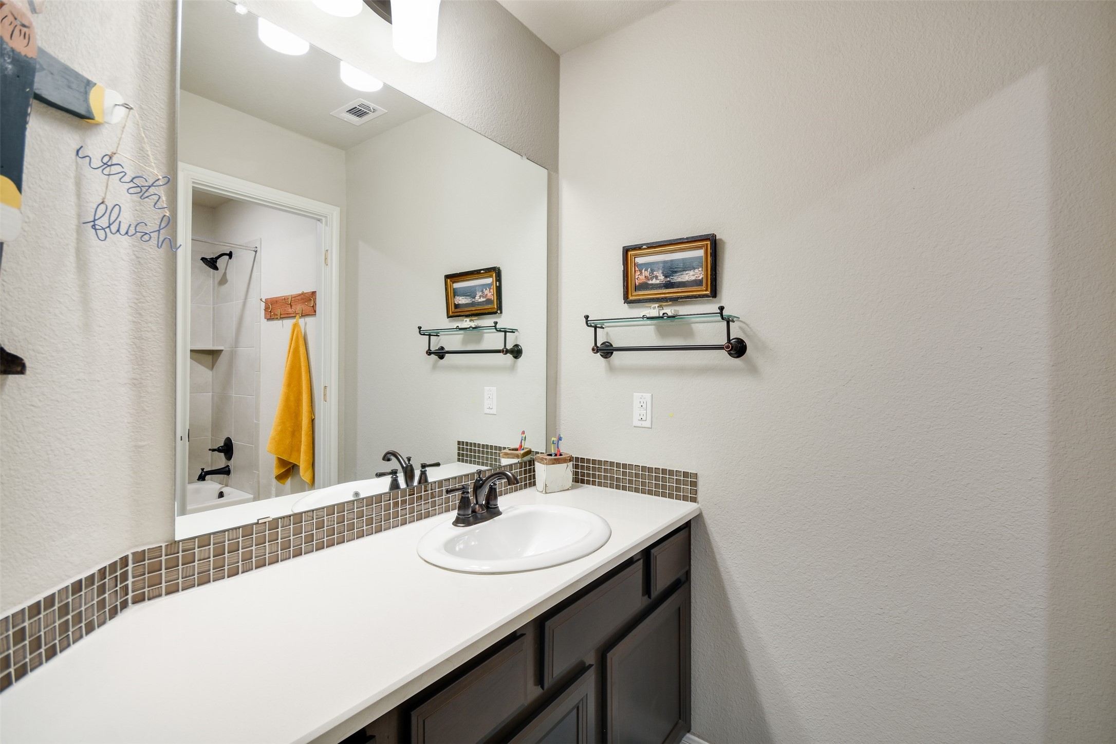 105 Potts Street Georgetown, TX 78628 - Photo 24 of 37 a bathroom with a sink and a mirror
