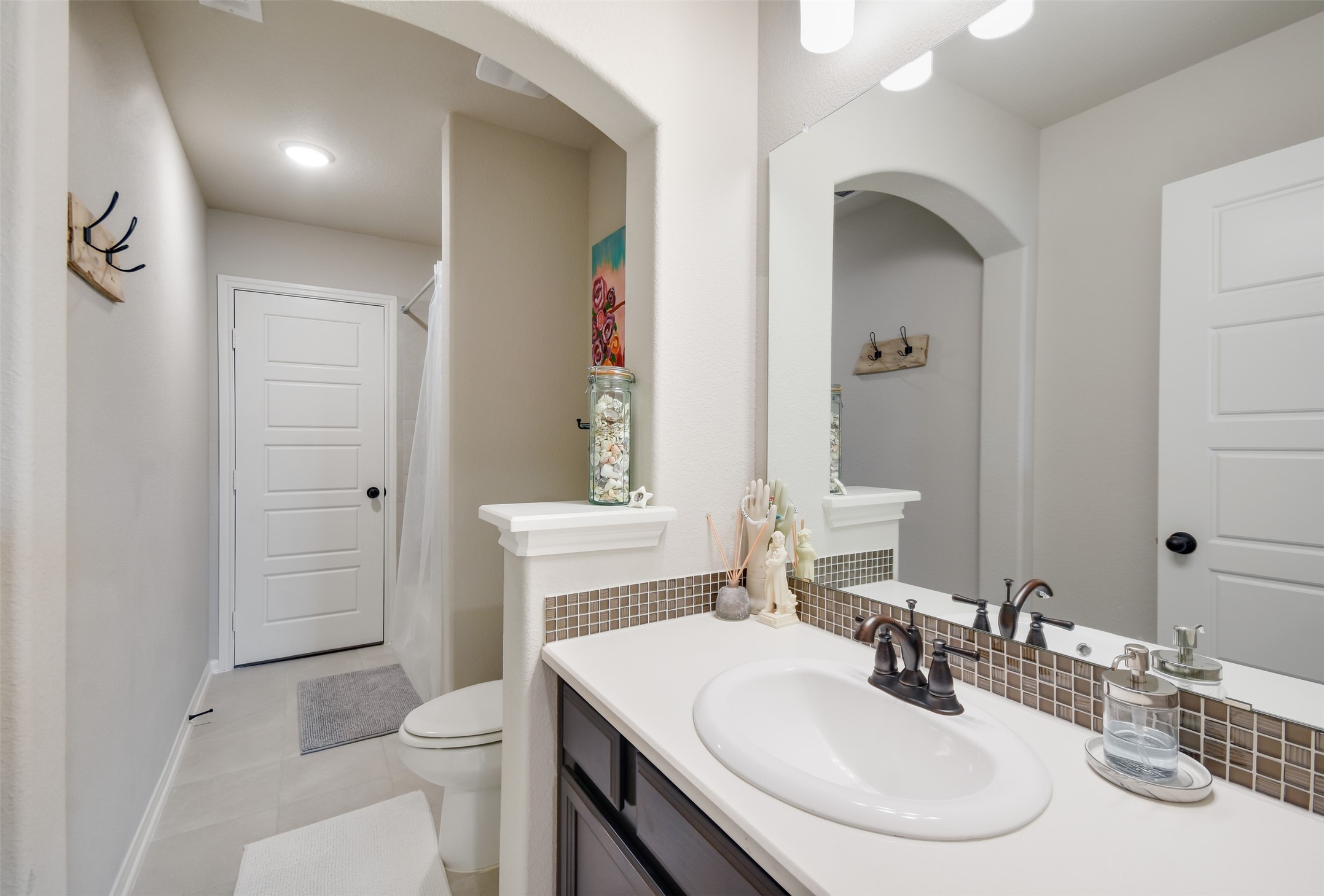 105 Potts Street Georgetown, TX 78628 - Photo 27 of 37 a bathroom with a sink toilet vanity and shower