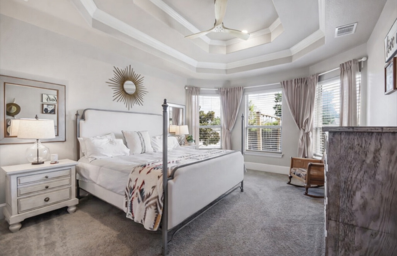 105 Potts Street Georgetown, TX 78628 - Photo 28 of 37 a spacious bedroom with a bed and a chandelier