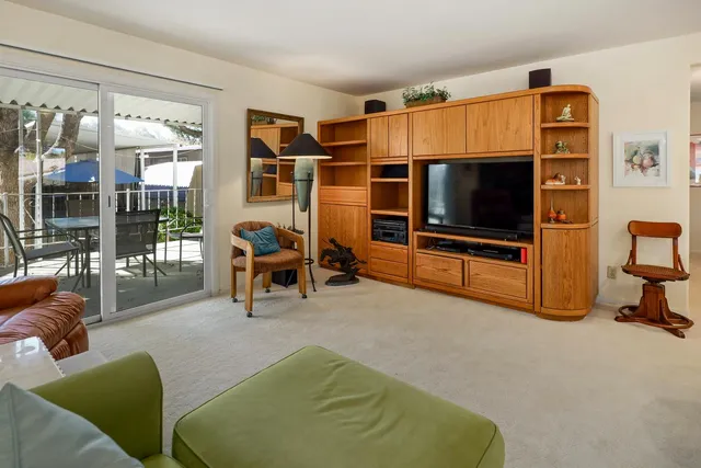 a living room with furniture gym equipment and a flat screen tv