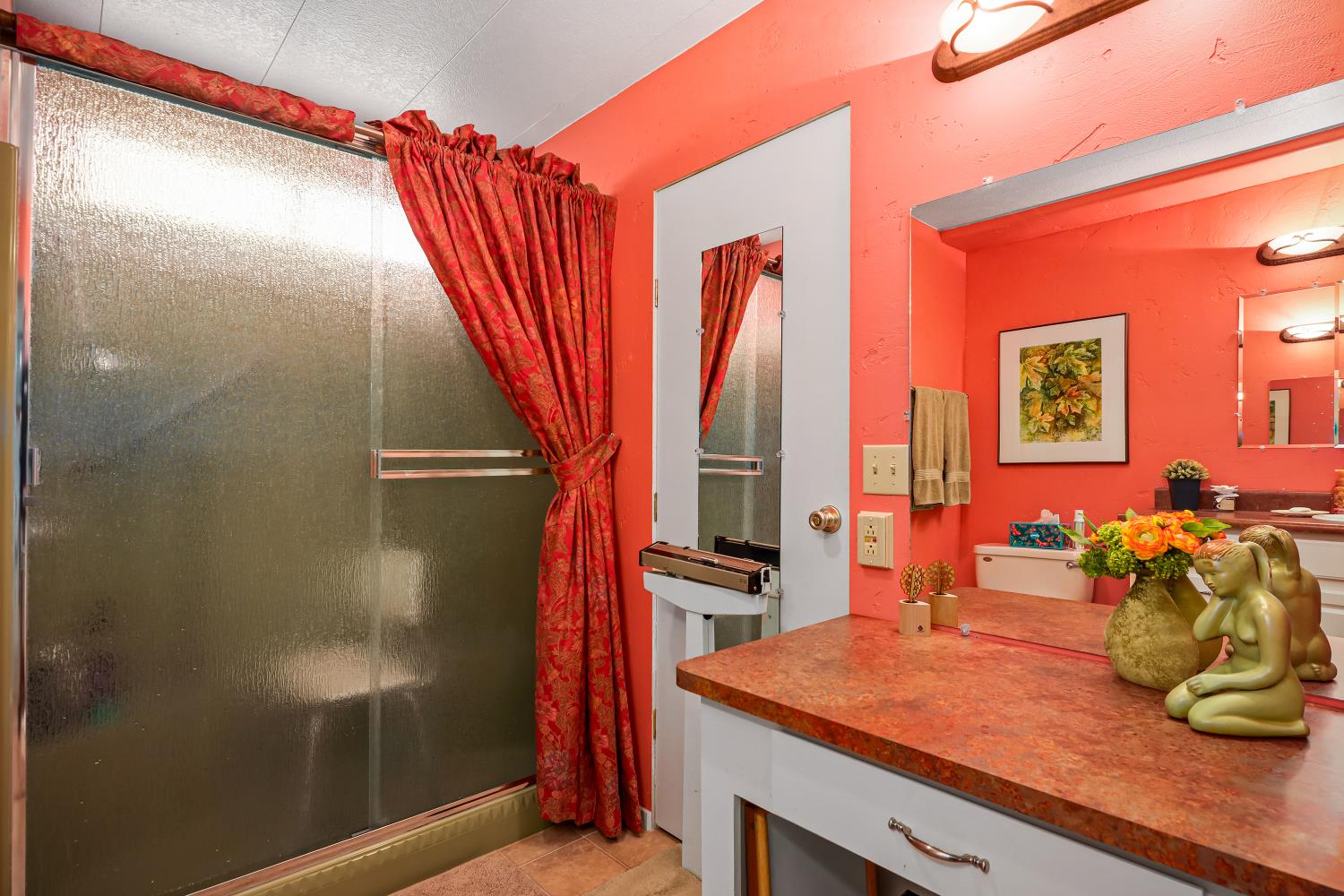 1330 Calaveritas Road, Unit 62 San Andreas, CA 95249 - Photo 22 of 47 a bathroom with a sink a mirror and a shower