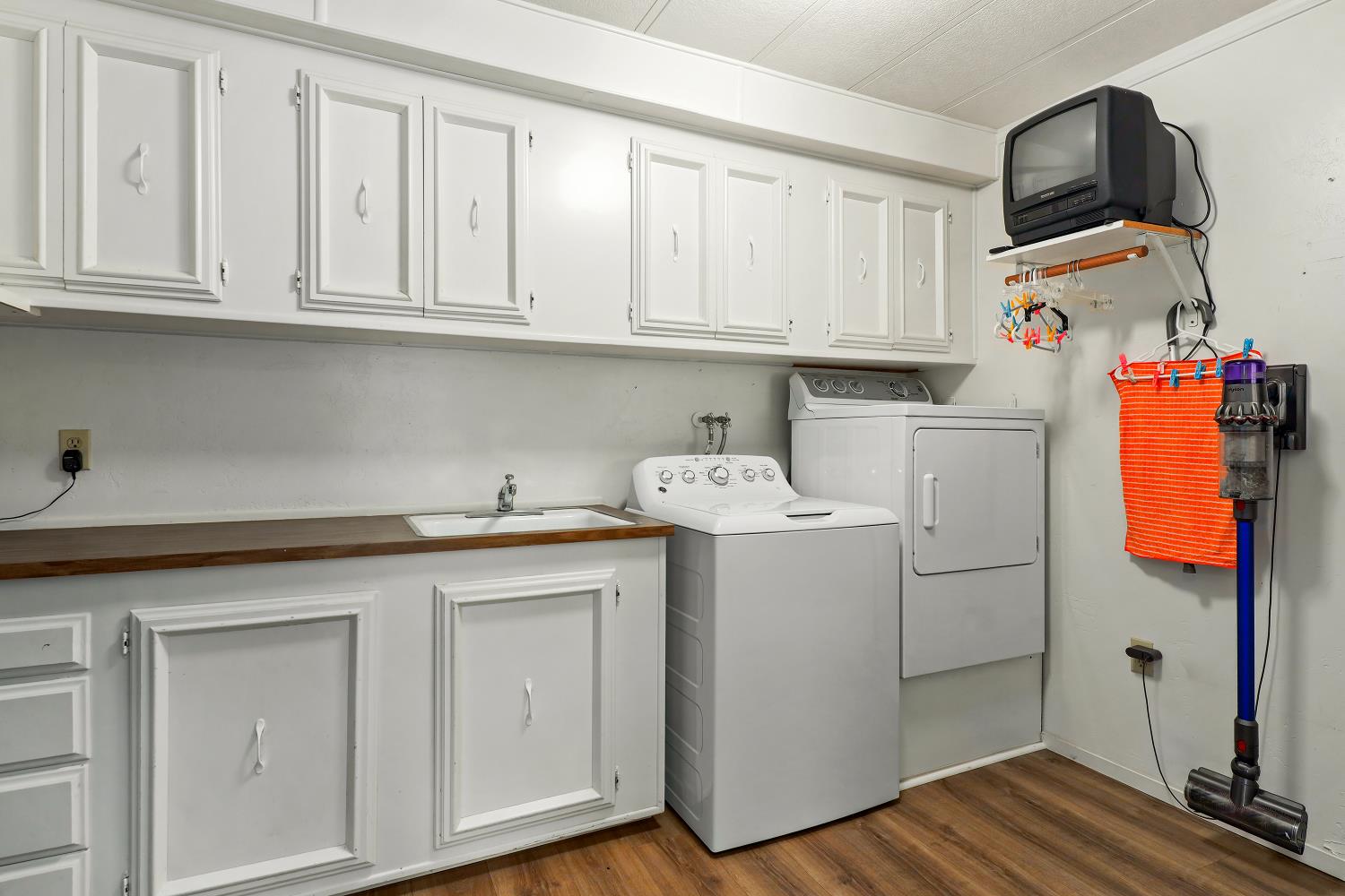 1330 Calaveritas Road, Unit 62 San Andreas, CA 95249 - Photo 30 of 47 a utility room with cabinets washer and dryer