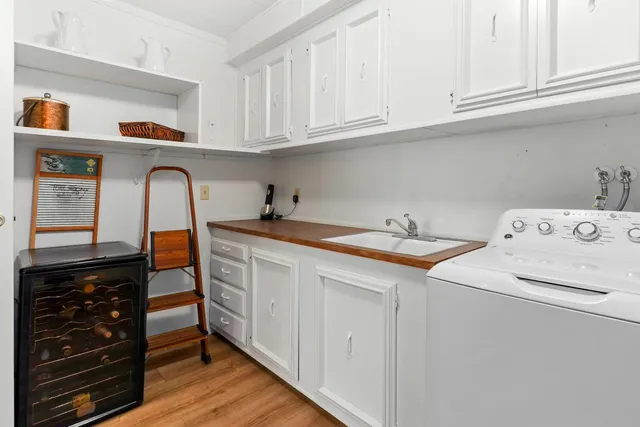 a utility room with sink dryer and washer