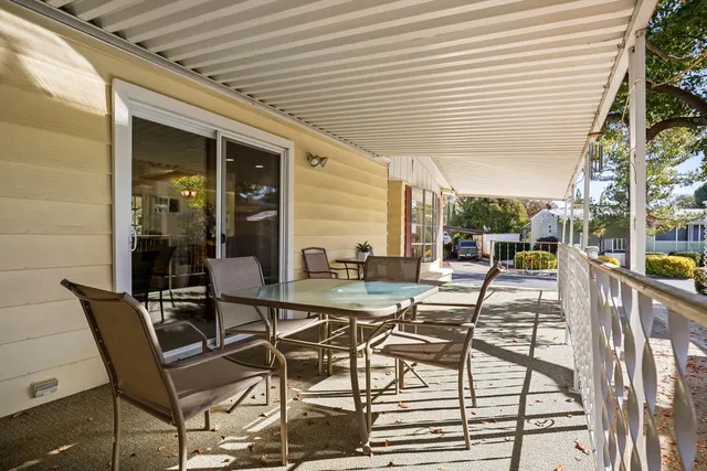 a view of a patio with table and chairs and potted plants