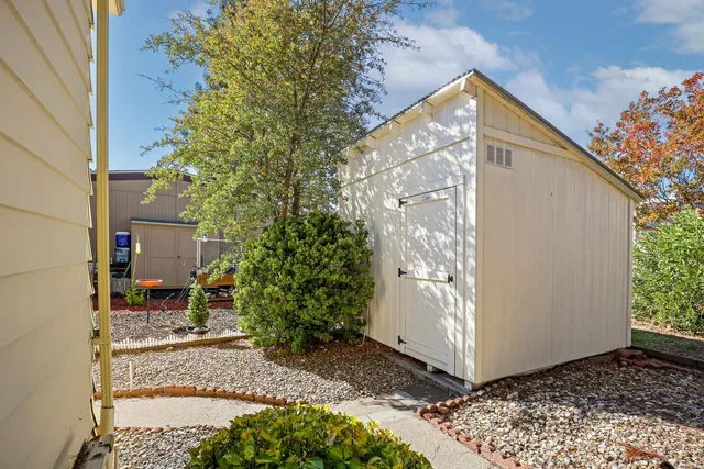 a backyard of a house with a tree