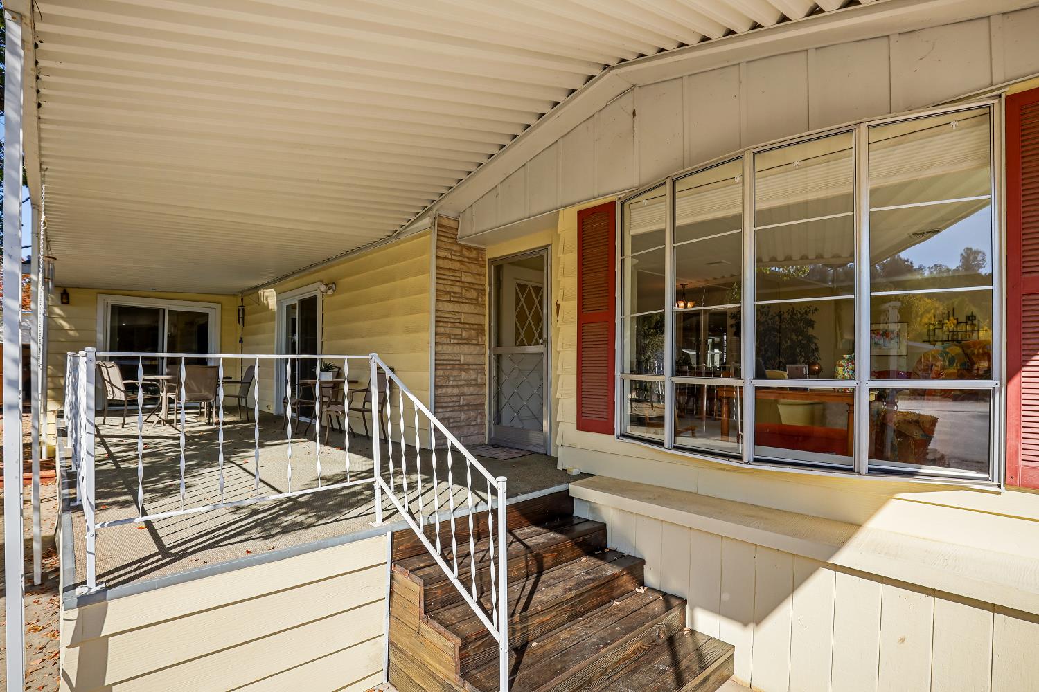 1330 Calaveritas Road, Unit 62 San Andreas, CA 95249 - Photo 42 of 47 a view of a balcony with a large window and wooden floor