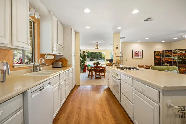 a large kitchen with stainless steel appliances lots of counter space and a sink