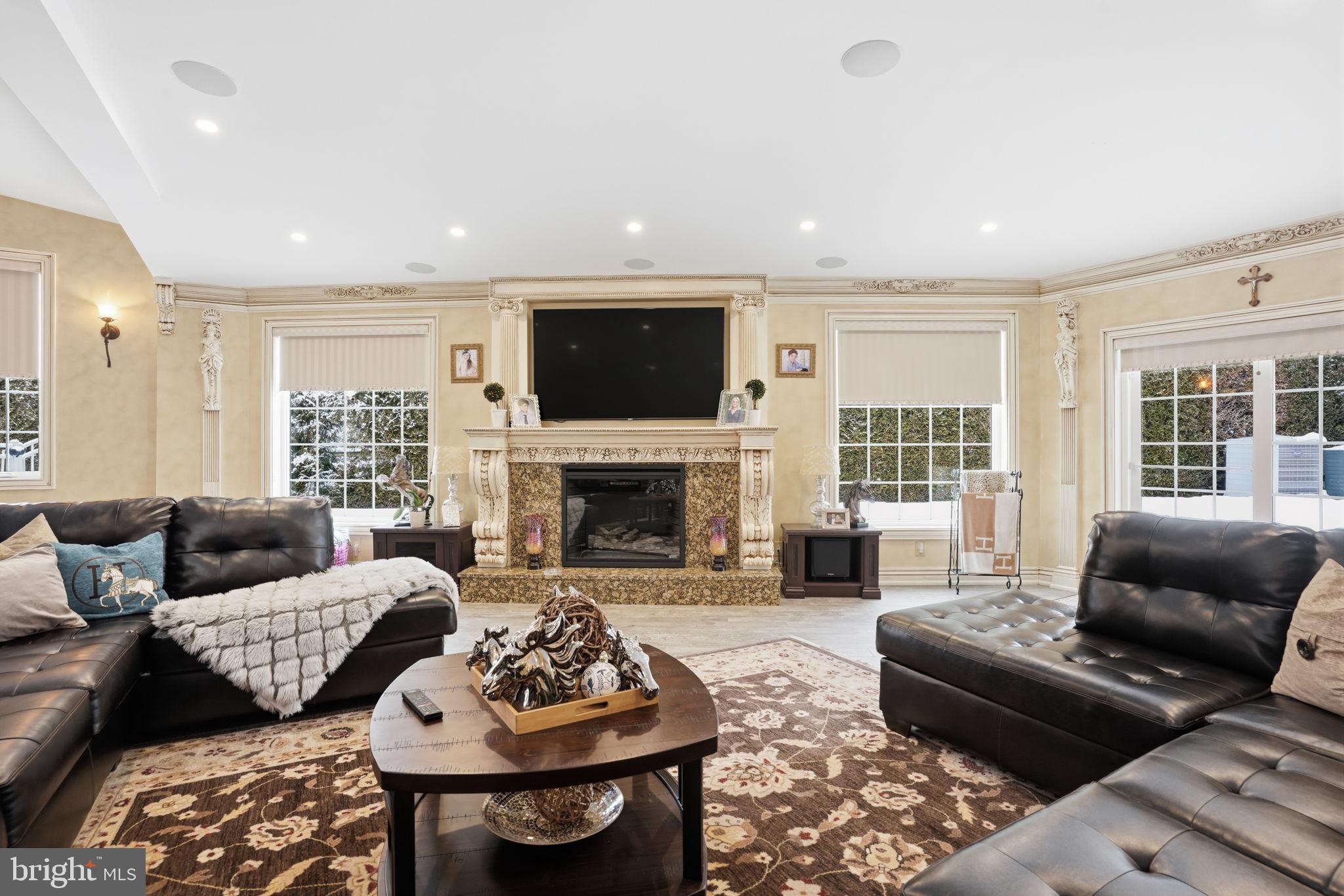 1066 Washington Crossing Road Washington Crossing, PA 18977 - Photo 32 of 92 a living room with furniture a fireplace and a flat screen tv