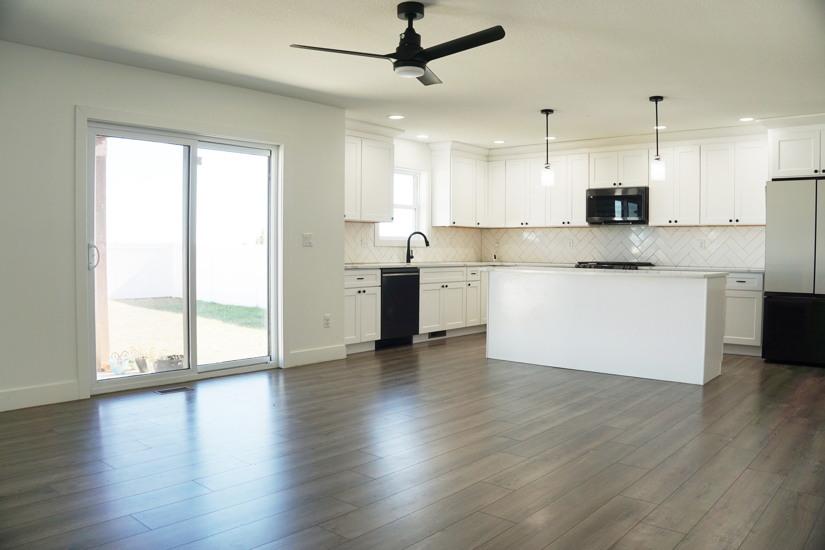 752 Kristin Drive Normal, IL 61761 - Photo 12 of 36 a large kitchen with granite countertop a stove top oven a sink and white cabinets with wooden floor
