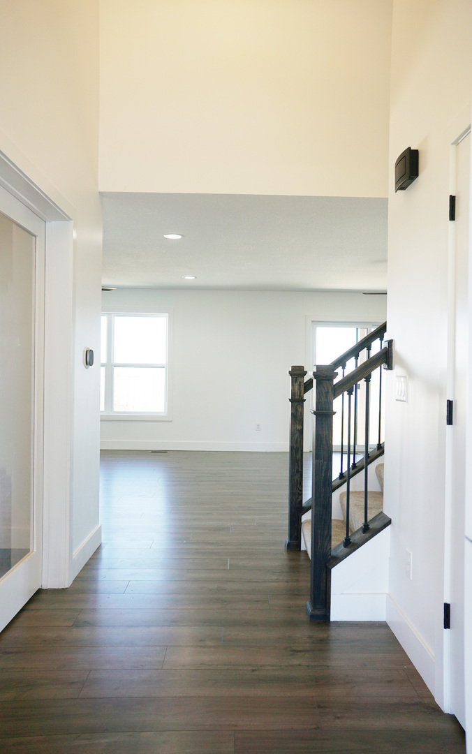 752 Kristin Drive Normal, IL 61761 - Photo 8 of 36 a view of empty room with wooden floor and fan