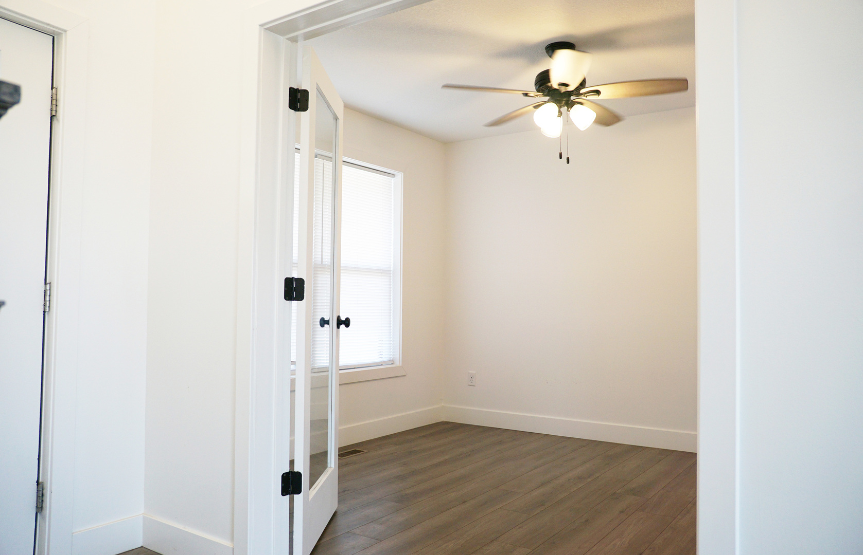 752 Kristin Drive Normal, IL 61761 - Photo 9 of 36 an empty room with wooden floor fan and windows