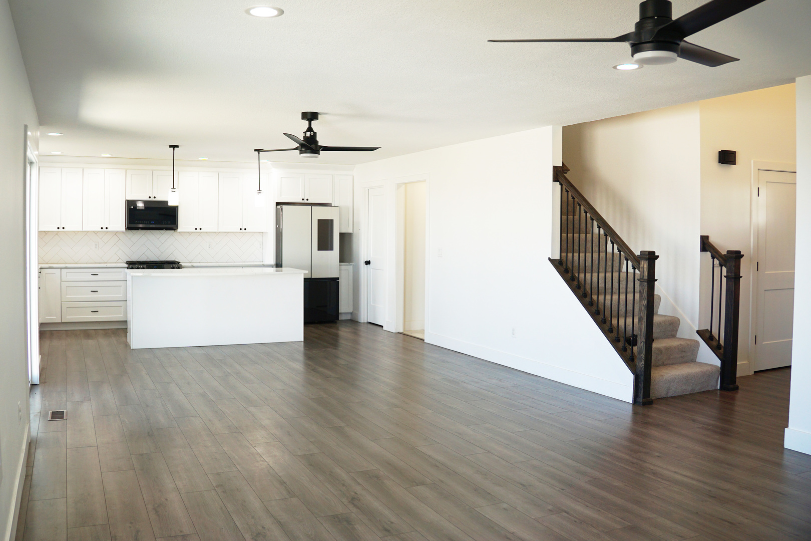 752 Kristin Drive Normal, IL 61761 - Photo 10 of 36 a view of a kitchen with wooden floor and a ceiling fan