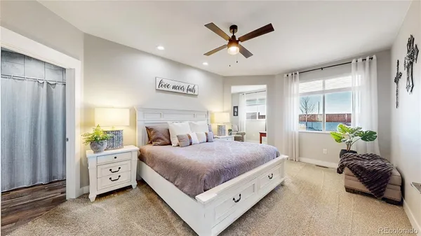 a spacious bedroom with a bed and a chandelier