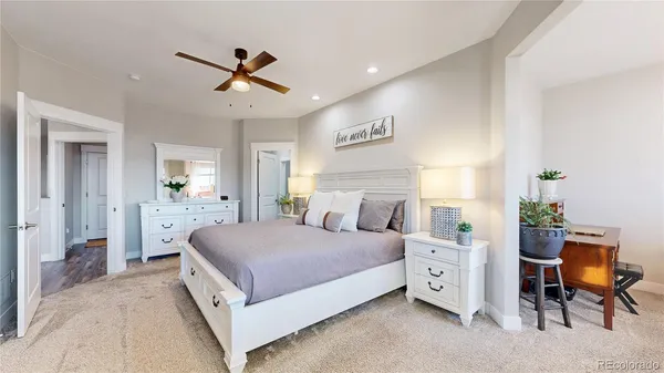 a spacious bedroom with a bed and a chandelier