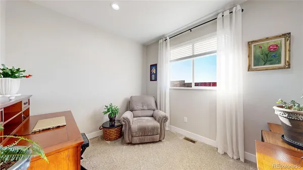 a room with furniture and a potted plant