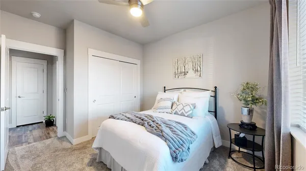 a bedroom with a bed and a painting on the wall