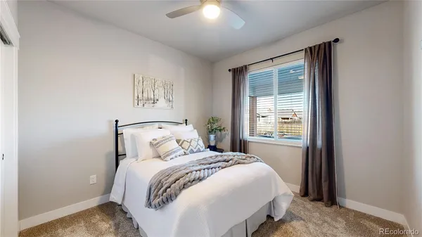 a bedroom with a large bed and a window