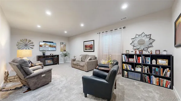 a living room with furniture a shelf and a book shelf