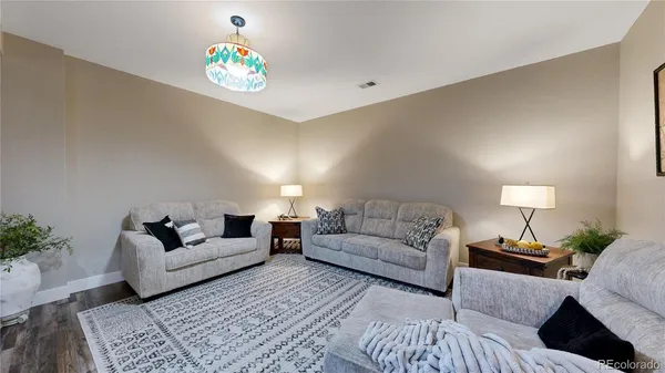 a living room with furniture and a chandelier