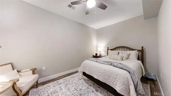 a bedroom with a bed and a chandelier fan