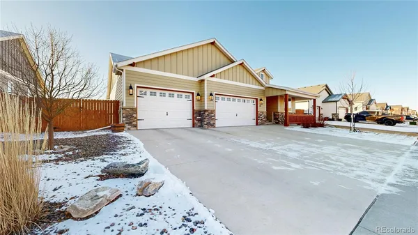 a view of a house with a yard covered in snow