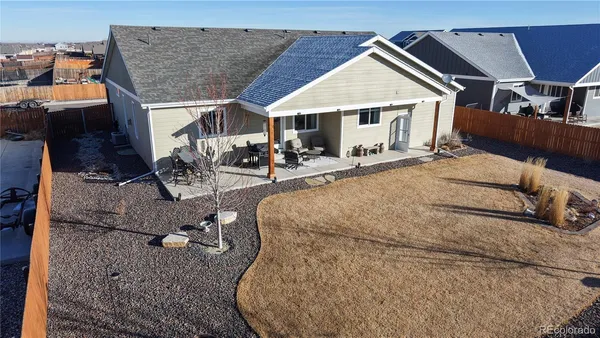 a view of a house with backyard and sitting area