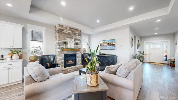 a living room with fireplace furniture and a wooden floor