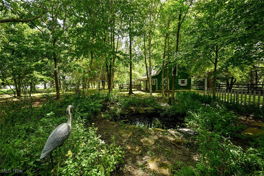 View of yard with waterfall pond