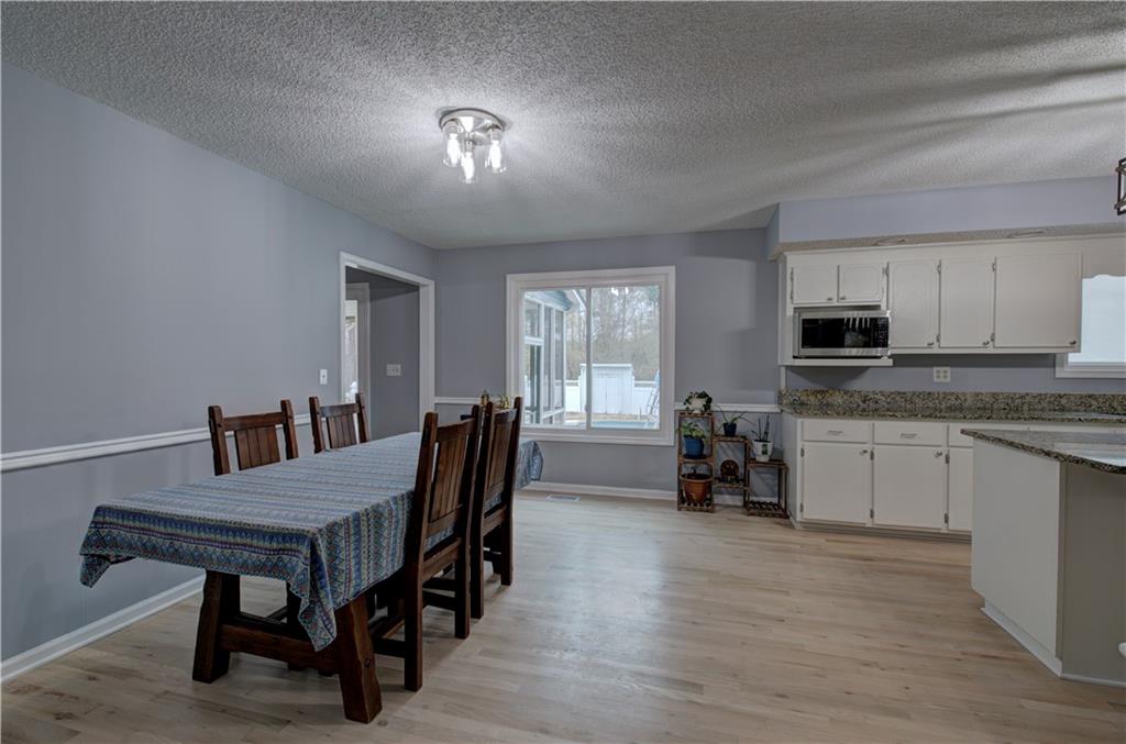 16 High Point Drive Southwest Cartersville, GA 30120 - Photo 11 of 44 a view of a dining room with furniture and a chandelier