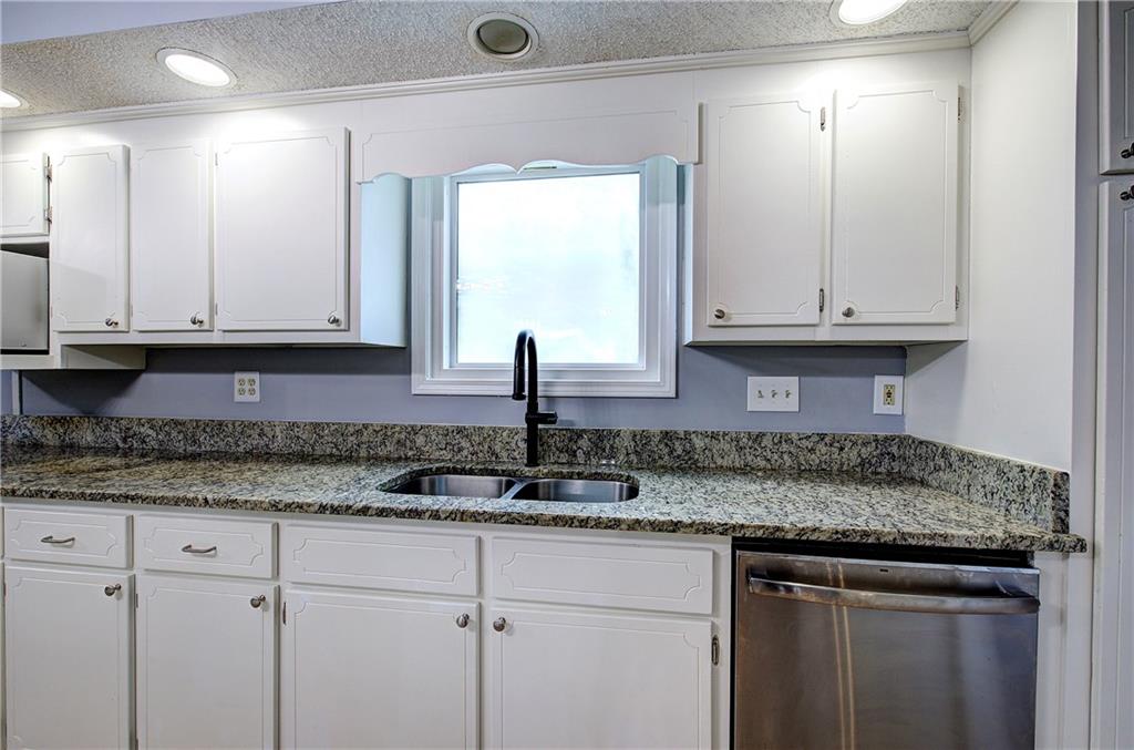 16 High Point Drive Southwest Cartersville, GA 30120 - Photo 16 of 44 a kitchen with granite countertop white cabinets and sink